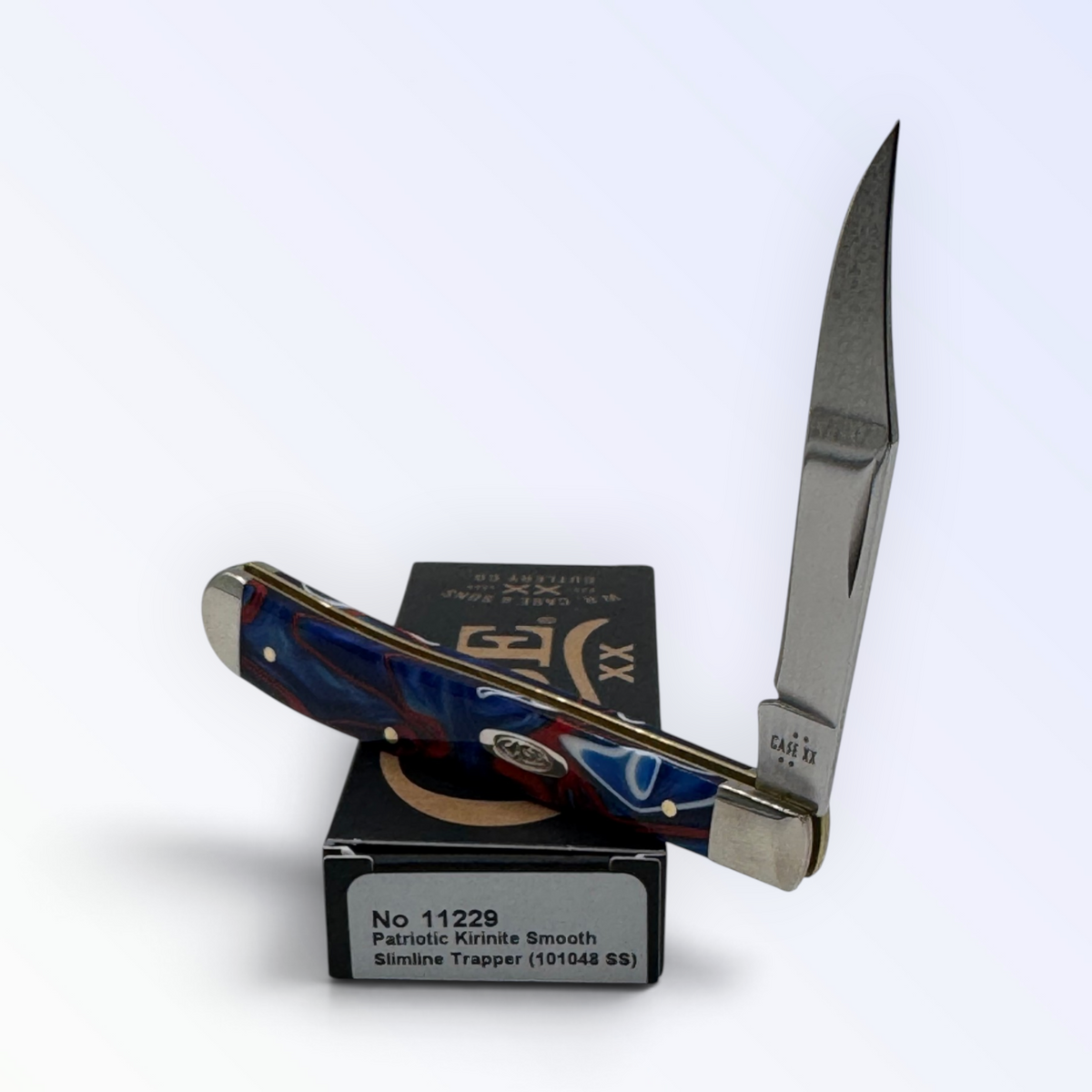 Case XX 11229 Slimline Trapper in Patriotic Kirinite — angled open view on Case XX packaging