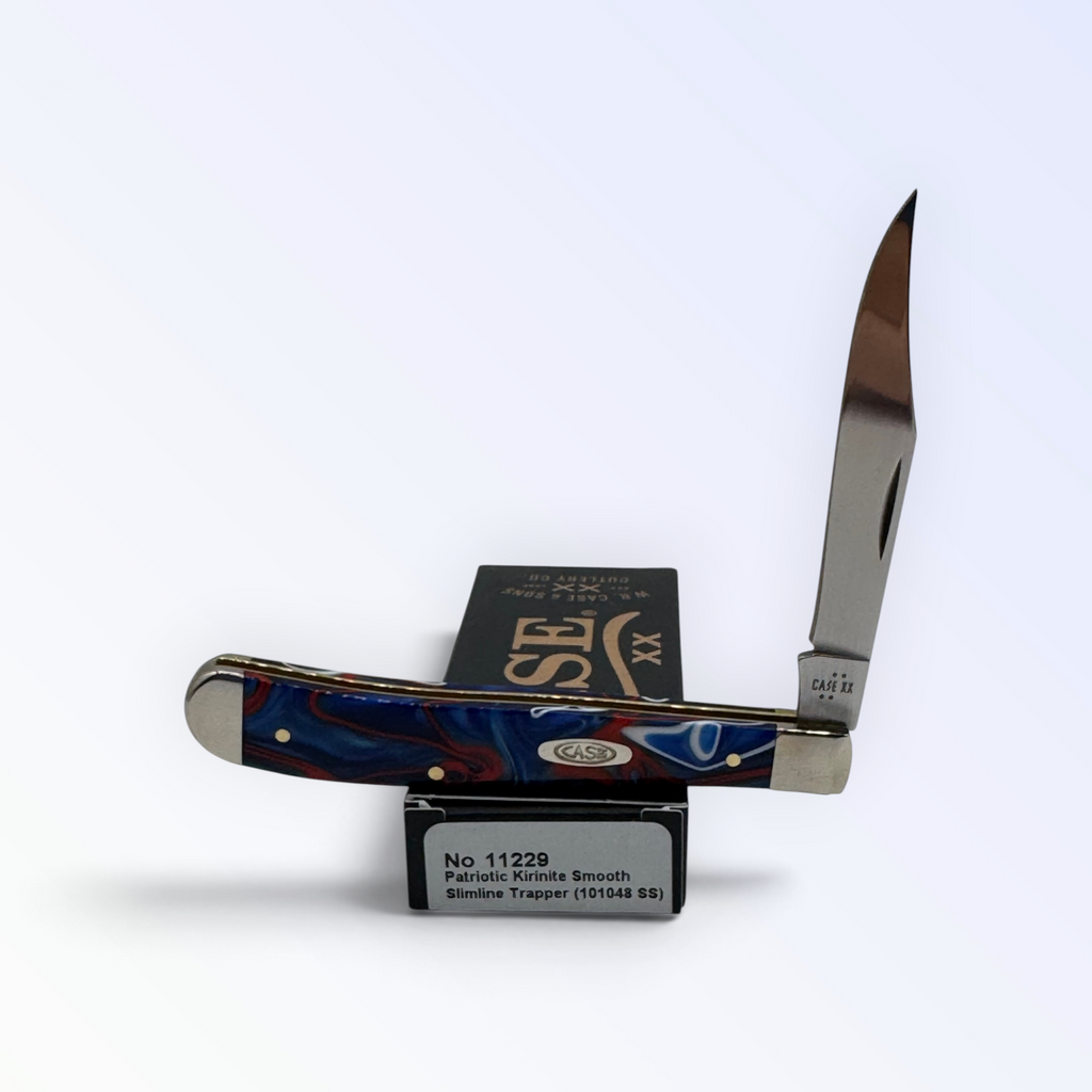 Case XX Slimline Trapper with Patriotic Kirinite and clip blade, SKU 11229 — blades open resting on the factory box