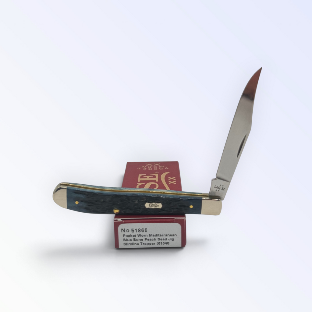 Case XX Slimline Trapper Peach Seed Mediterranean Blue Bone with SKU 51865 — blades open resting on the factory box