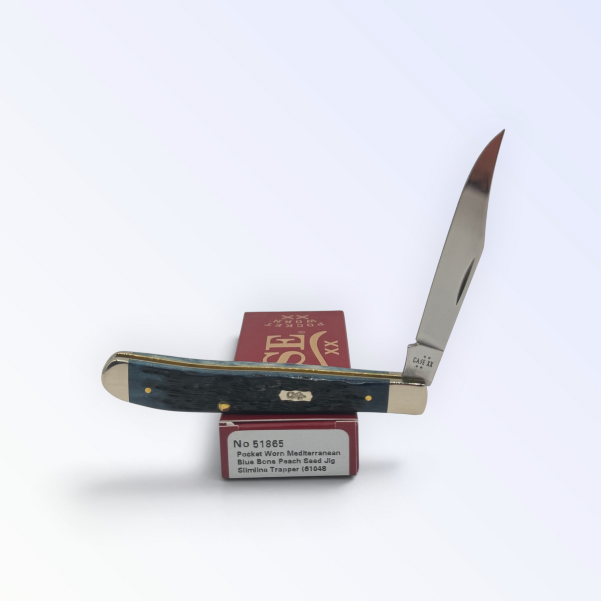 Case XX Slimline Trapper Peach Seed Mediterranean Blue Bone with SKU 51865 — blades open resting on the factory box