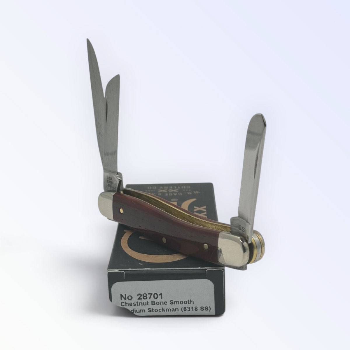 Catalog 28701 Case XX Smooth Chestnut Bone Medium Stockman — open blades resting on factory packaging