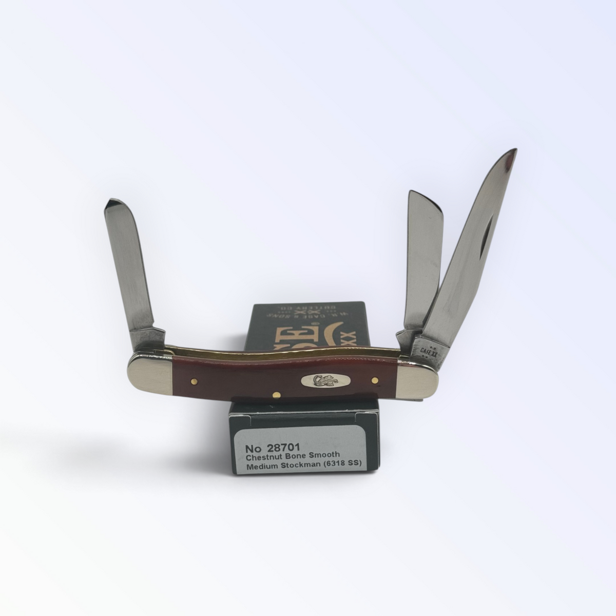 Case XX Smooth Chestnut Bone Medium Stockman with SKU 28701 — blades open resting on the factory box