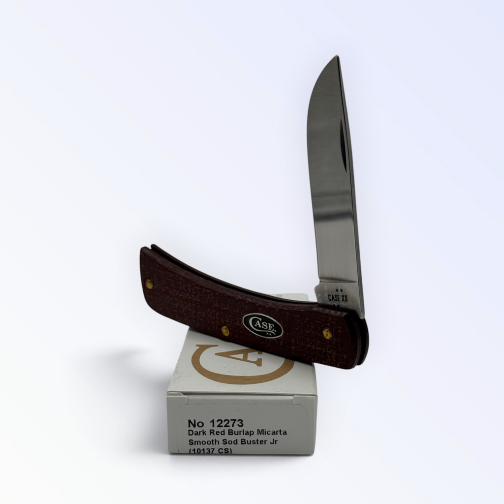 Case XX 12273 Sod Buster Jr in dark red burlap Micarta — angled open view on Case XX packaging