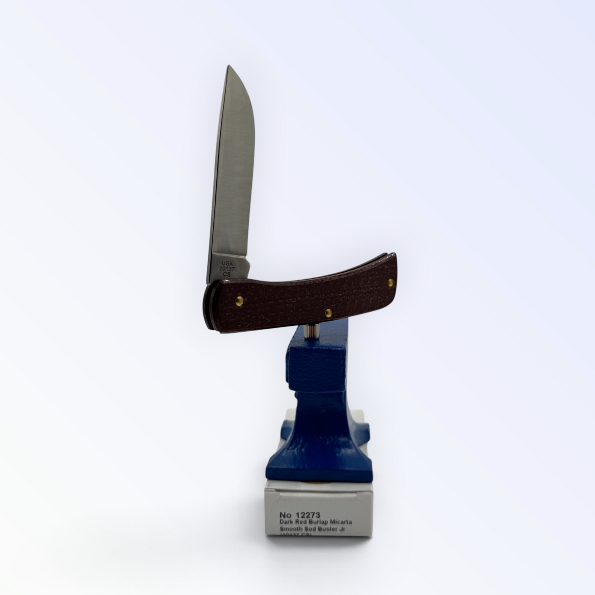 Catalog 12273 Case XX Sod Buster Jr — dark red burlap Micarta, close view of handle texture with blades open on box