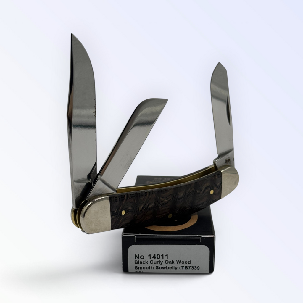 Catalog 14011 Case XX Sowbelly Stockman — black curly oak wood, close view of handle texture with blades open on box