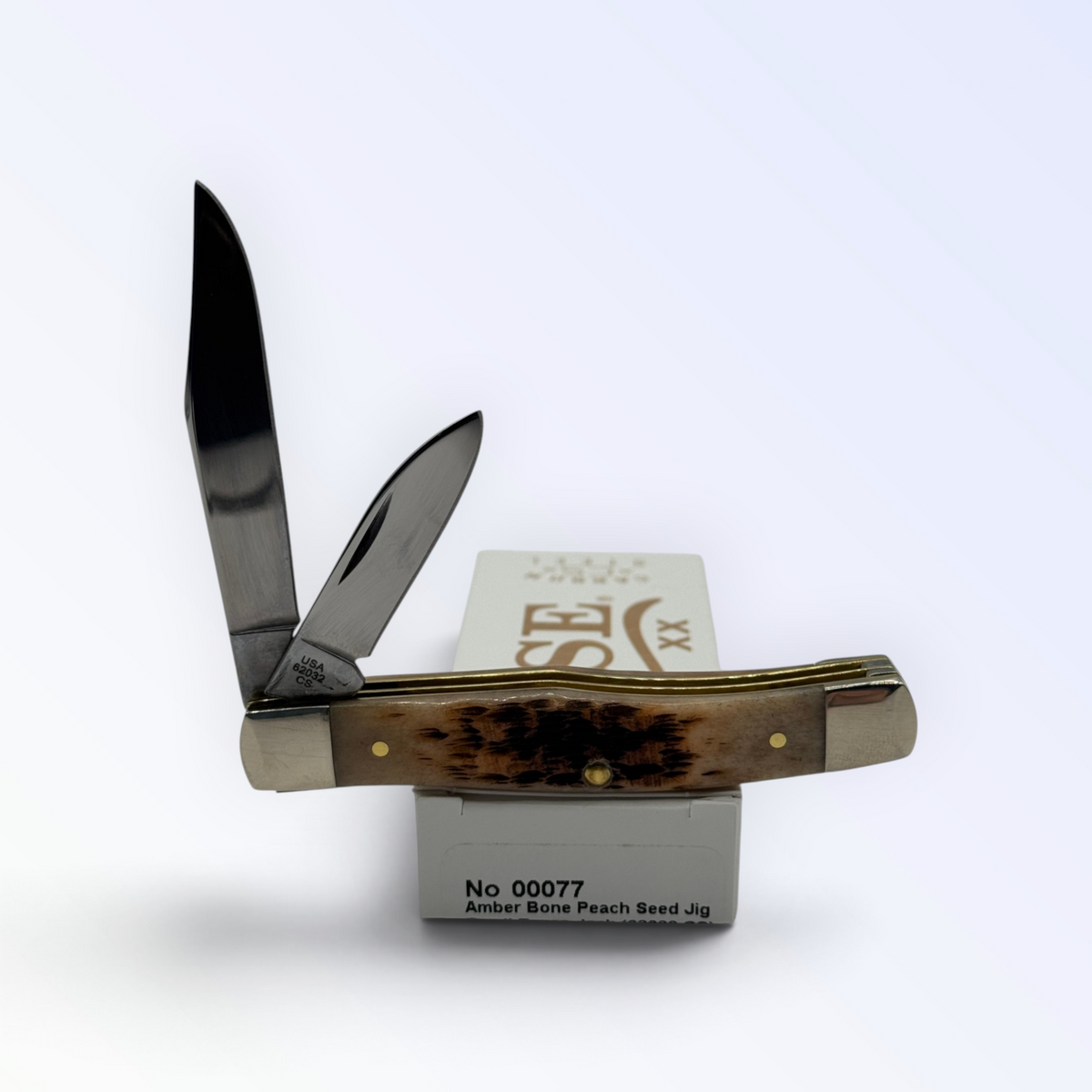 Pigeon Roost Knives Case XX Texas Jack pocket knife with amber bone handle and two carbon steel blades on its box.