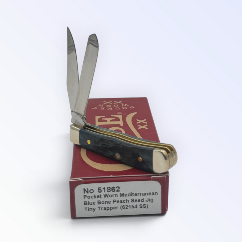 Catalog 51862 Case XX Tiny Trapper Pocket Worn Mediterranean Blue Bone — open blades resting on factory packaging