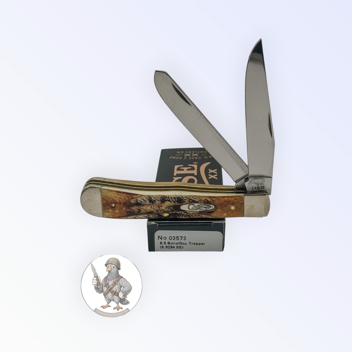 Case XX 6.5 BoneStag Trapper with BoneStag handles and large trapper pattern, SKU 03573 — blades open resting on the factory box
