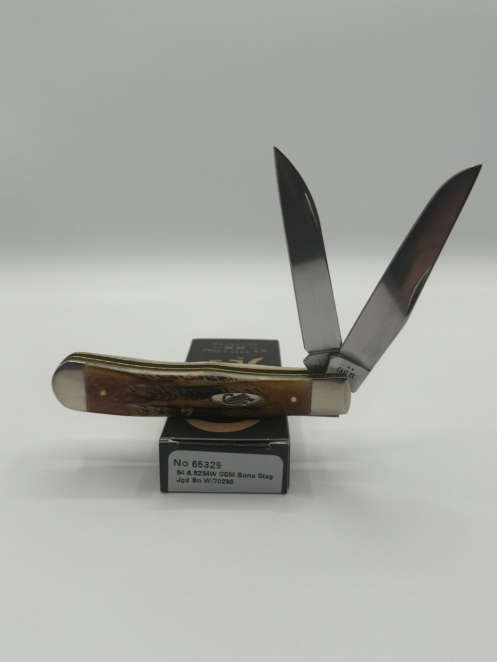 Case XX Trapper with 6.5 Bonestag with Wharncliffe, SKU 65329 — closed profile on the Case XX box