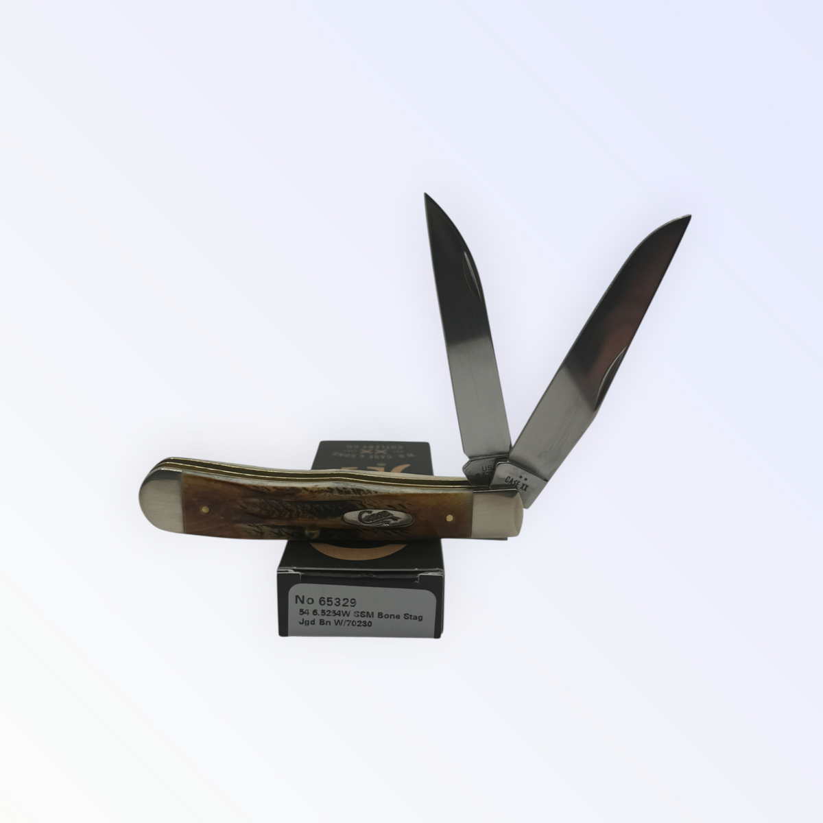 Case XX Trapper with 6.5 Bonestag with Wharncliffe, SKU 65329 — closed profile on the Case XX box