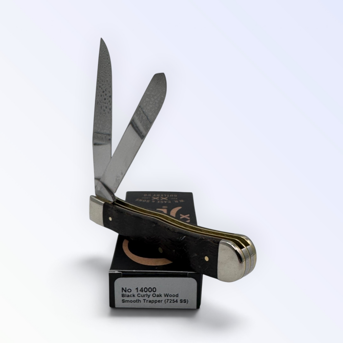 Case XX Trapper 14000: black curly oak wood, open on box with end label facing forward