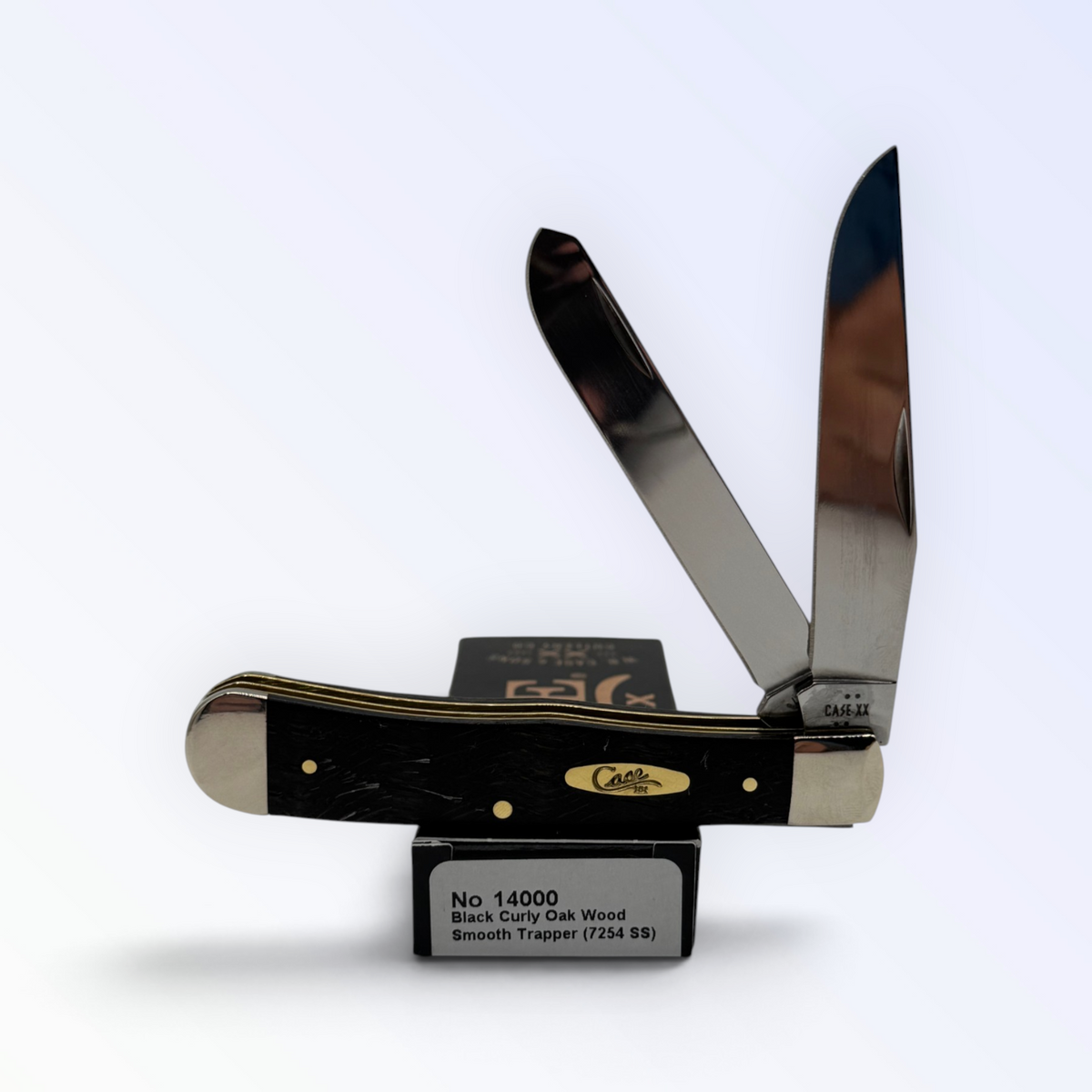 Case XX Trapper with black curly oak wood and clip and spey blades, SKU 14000 — blades open resting on the factory box