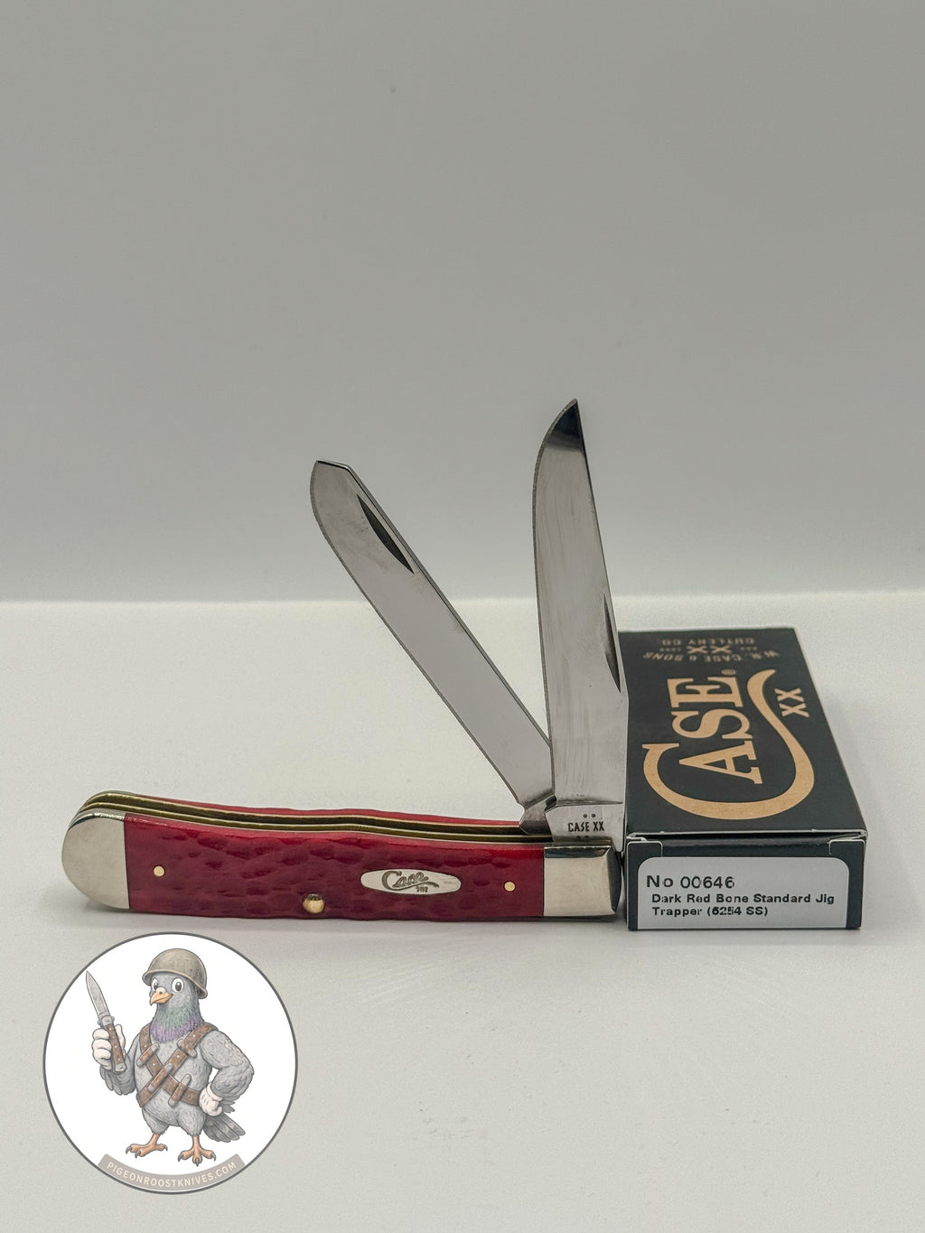 Case XX 00646 Trapper in Dark Red Jigged Bone 6254 SS — open blades resting on factory packaging