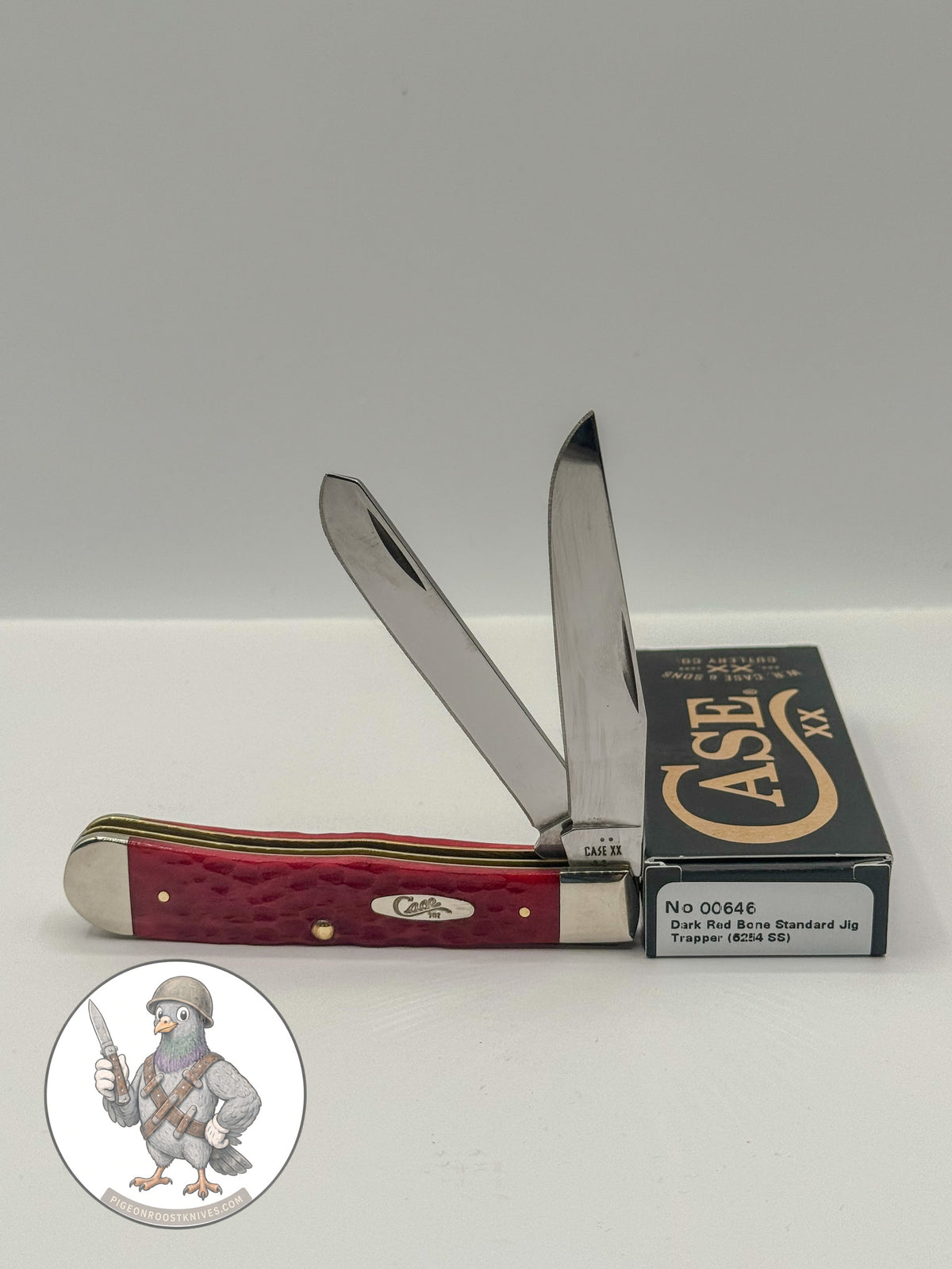 Case XX 00646 Trapper in Dark Red Jigged Bone 6254 SS — open blades resting on factory packaging