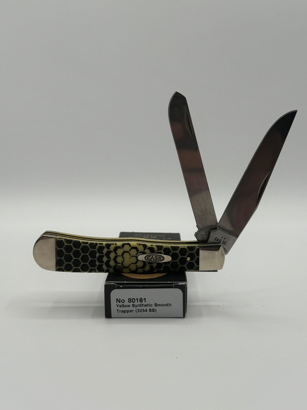 Case XX Trapper 80161HC: Honey Comb Smooth Yellow Synthetic, angled view showing handle texture and bolsters