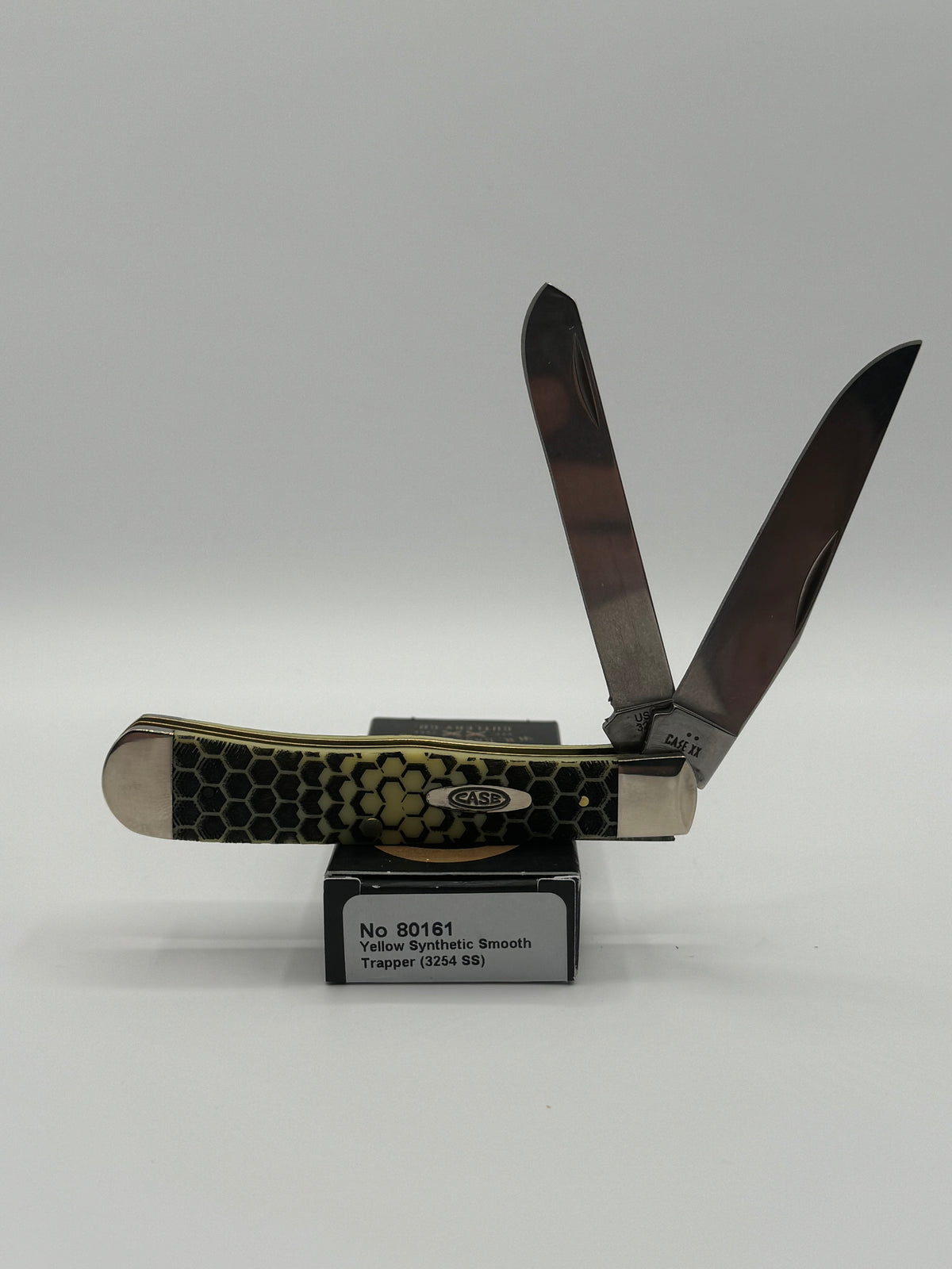 Case XX Trapper 80161HC: Honey Comb Smooth Yellow Synthetic, angled view showing handle texture and bolsters