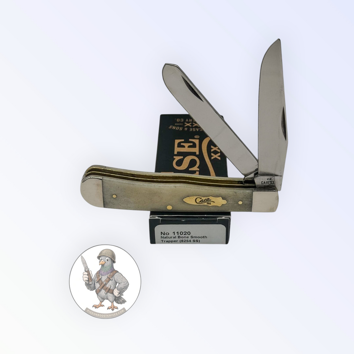 Case XX Trapper with smooth natural bone with brass shield and clip and spey blades, SKU 11020 — blades open resting on the factory box