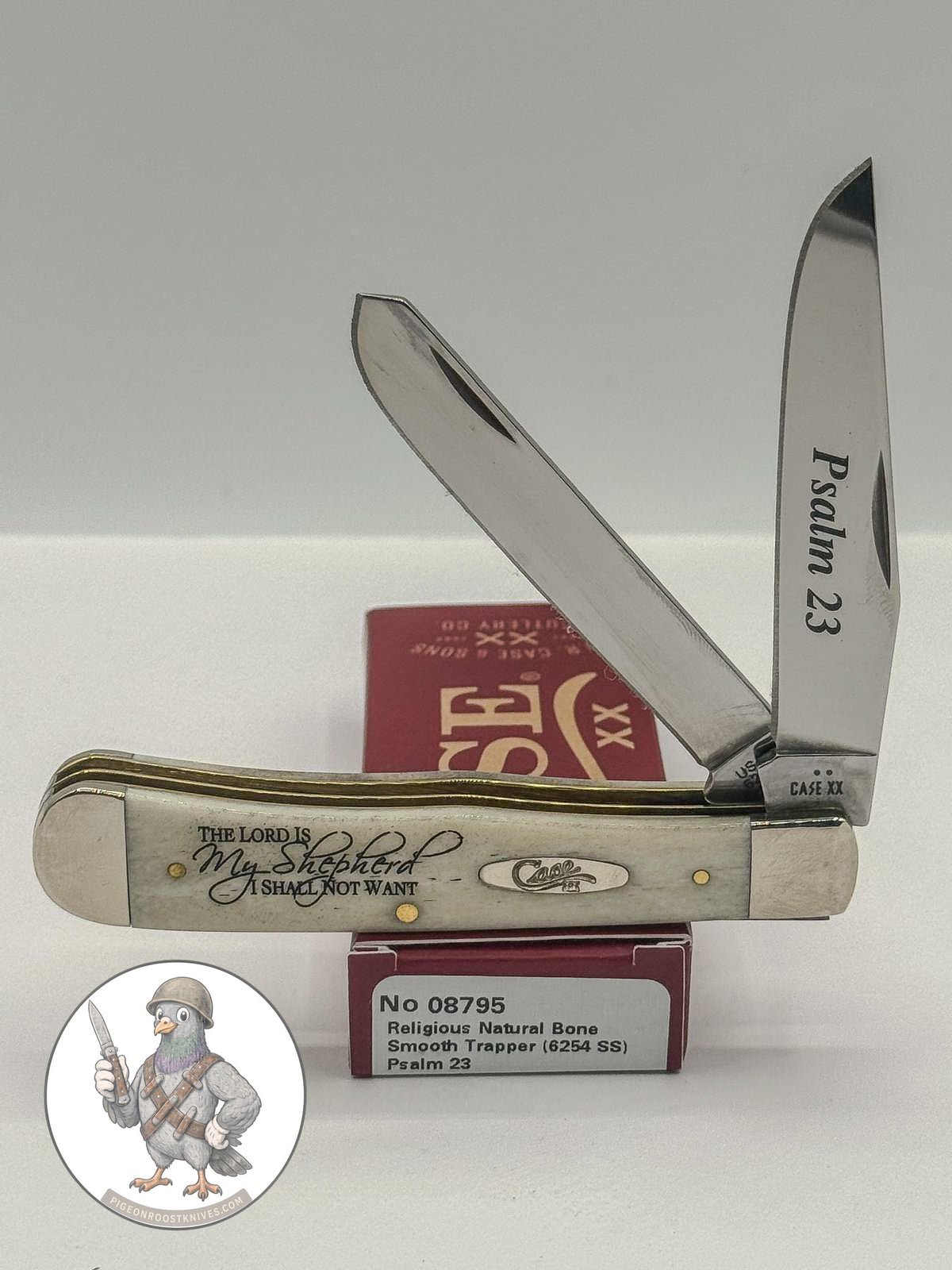 Case XX Trapper with Psalm 23 smooth natural bone and religious saying etched blades, SKU 08795 — blades open resting on the factory box
