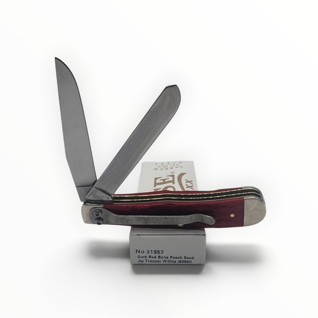 Pigeon Roost Knives Case XX Trapper pocket knife with dark red bone handle, carbon steel blades, and a pocket clip.