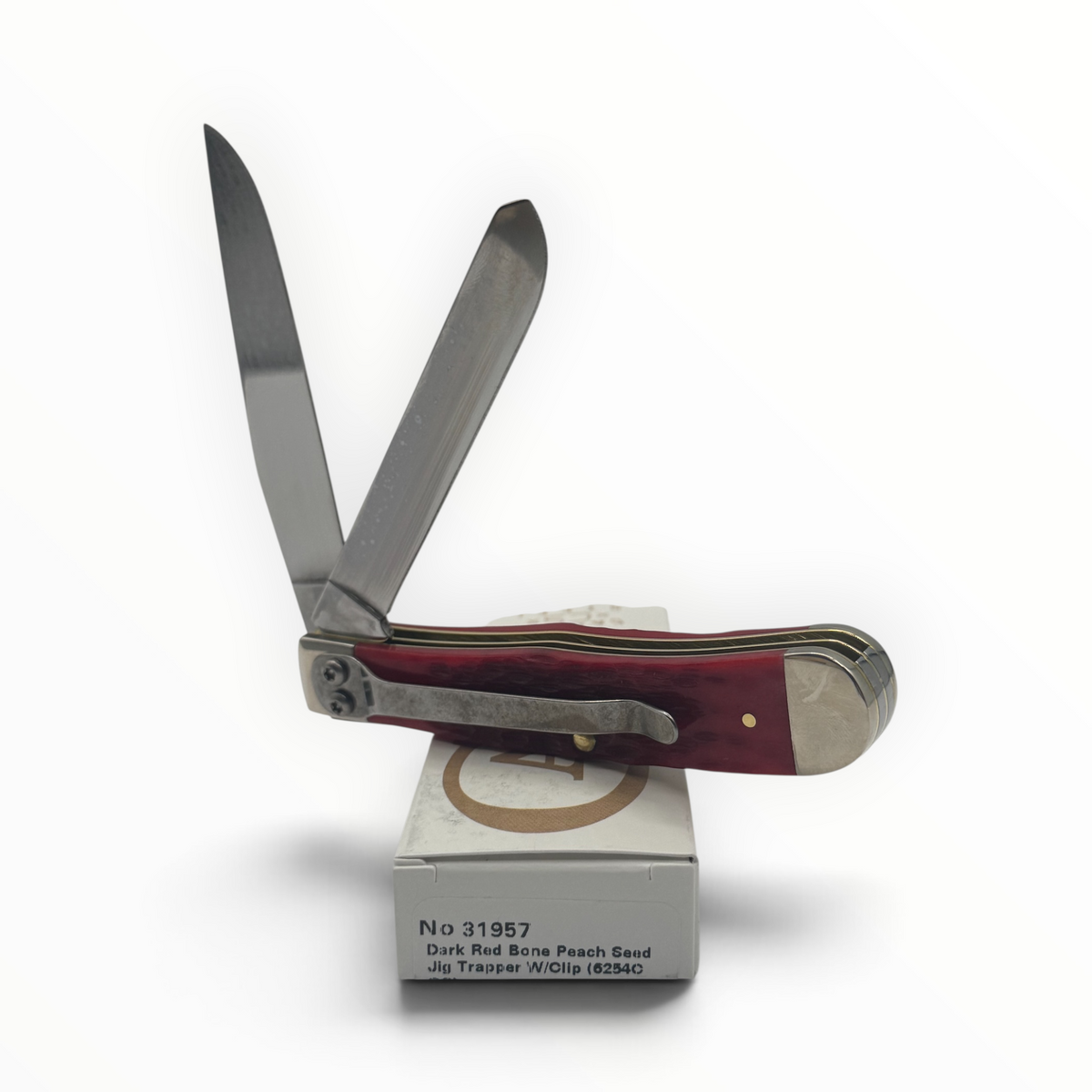 Pigeon Roost Knives Case XX Trapper pocket knife with dark red bone handle, carbon steel blades, and a pocket clip.