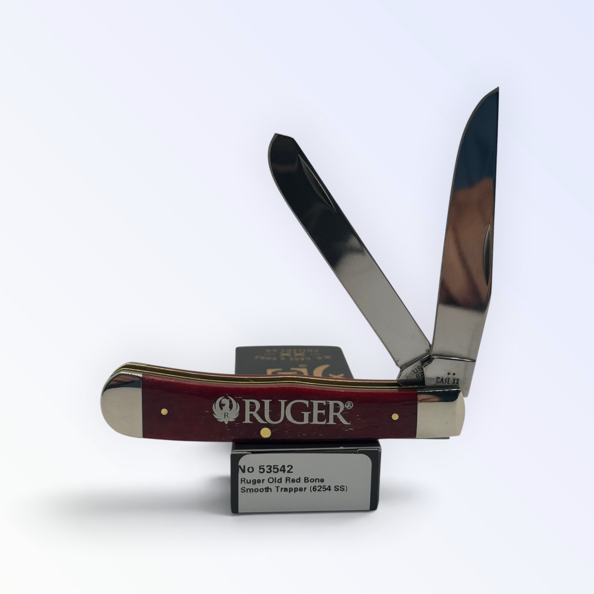Case XX Trapper with Ruger smooth red and clip and spey blades, SKU 53542 — blades open resting on the factory box