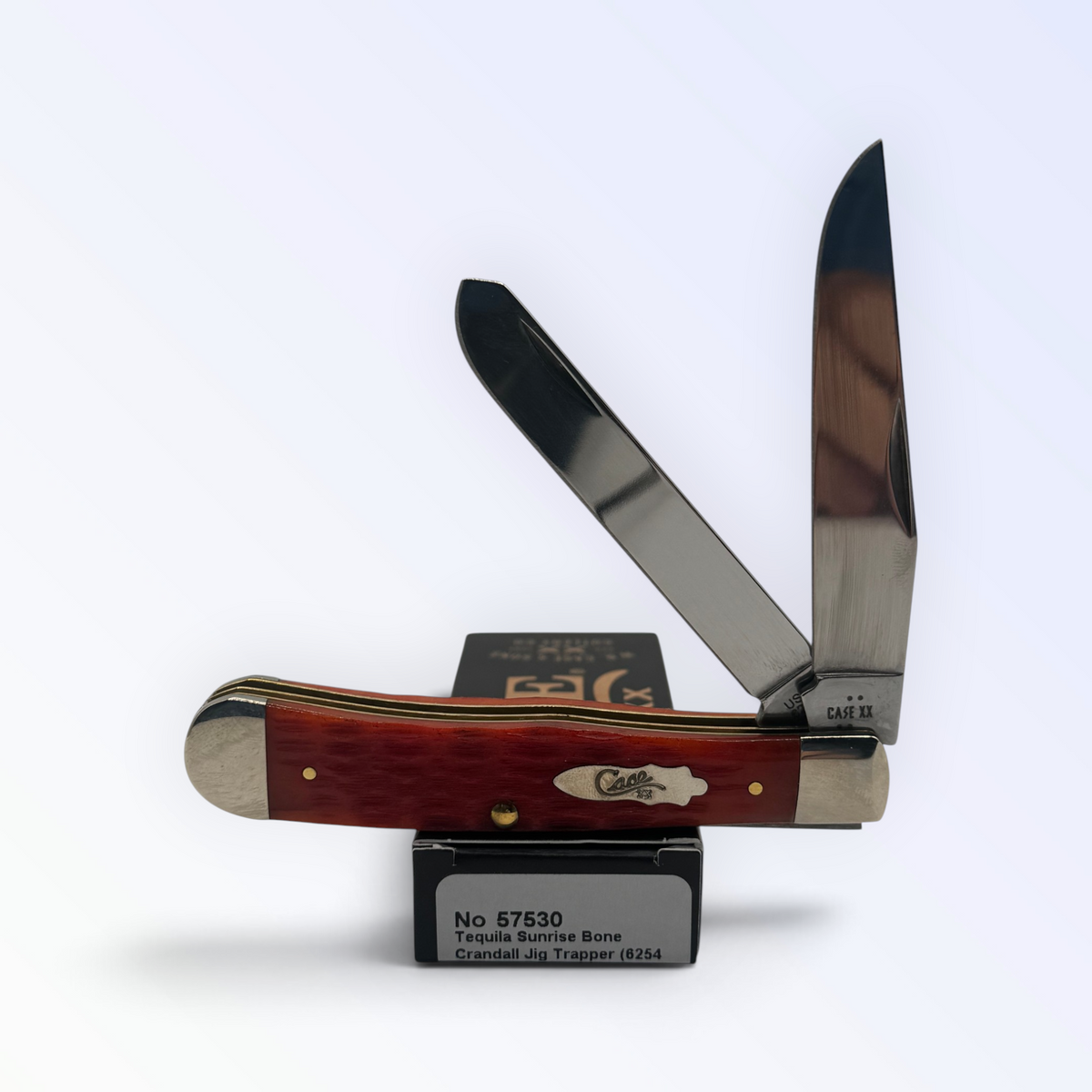 Trapper by Case XX featuring Tequila Sunrise Bone (57530), pocket-knife studio shot on retail box