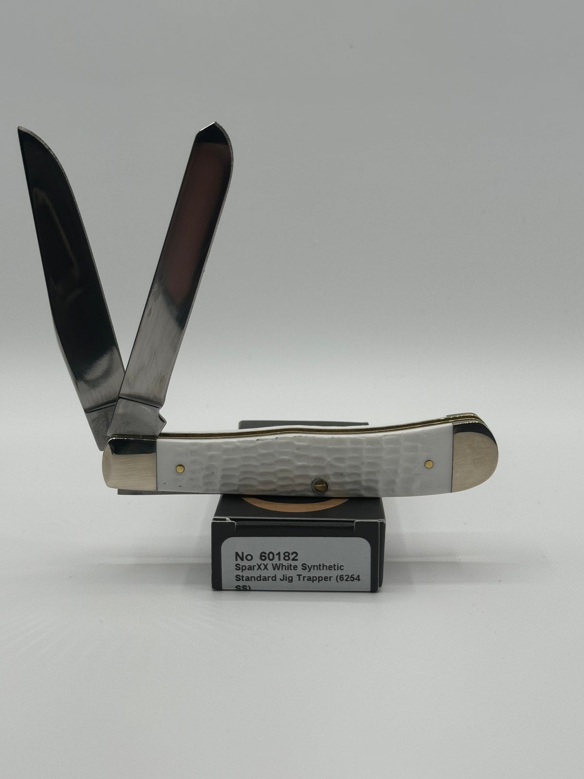Pigeon Roost Knives Case XX SparXX Trapper pocket knife with white jigged synthetic handle and two stainless blades.