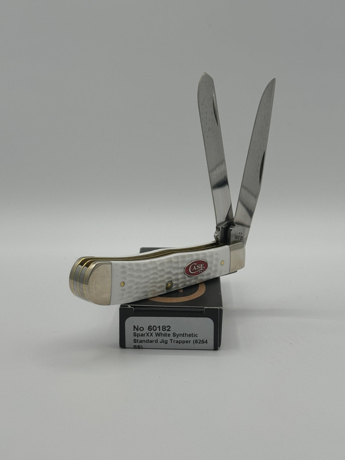 Pigeon Roost Knives Case XX SparXX Trapper pocket knife with white jigged synthetic handle and two stainless blades.