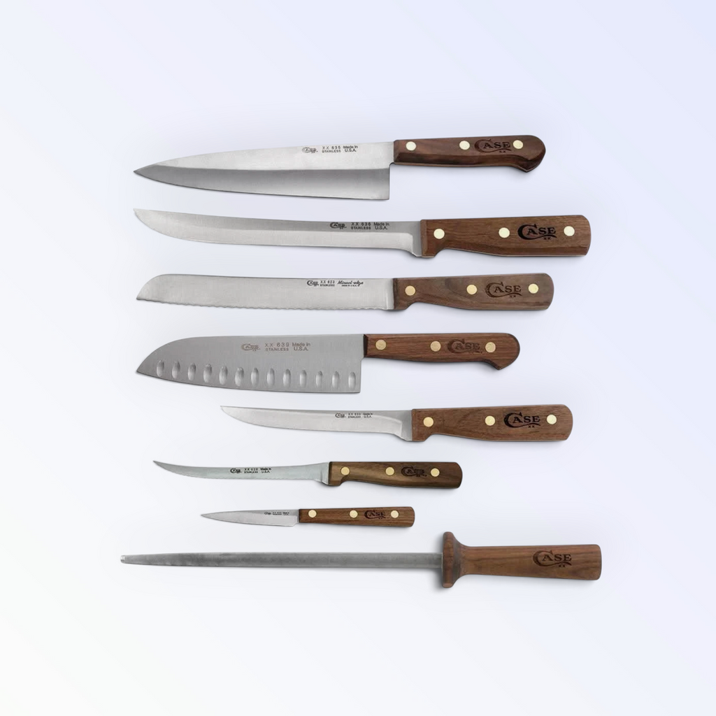 Case XX 10249 walnut-handle kitchen knives and sharpening steel — chef, slicer, bread, santoku laid out