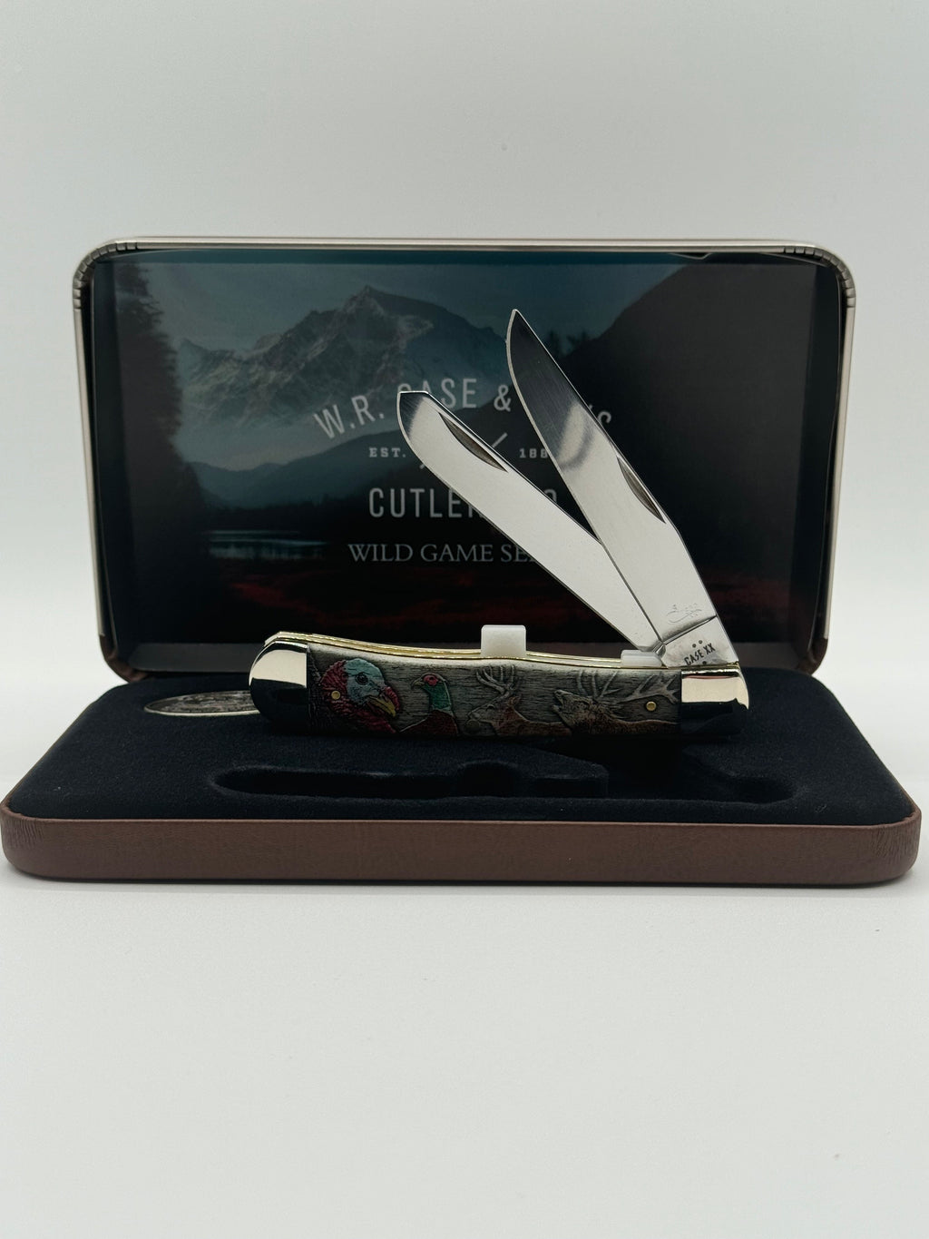 Pigeon Roost Knives Case XX Wild Game Series Trapper knife with smooth bone handle in a decorative display gift tin.