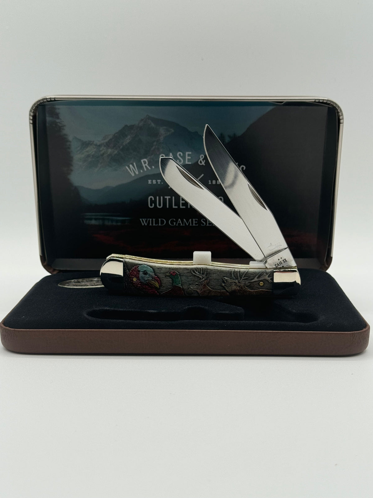 Pigeon Roost Knives Case XX Wild Game Series Trapper knife with smooth bone handle in a decorative display gift tin.