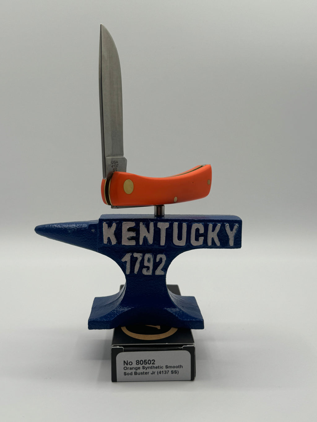Pigeon Roost Knives Case XX Sod Buster Jr pocket knife with a smooth orange synthetic handle on a Kentucky anvil