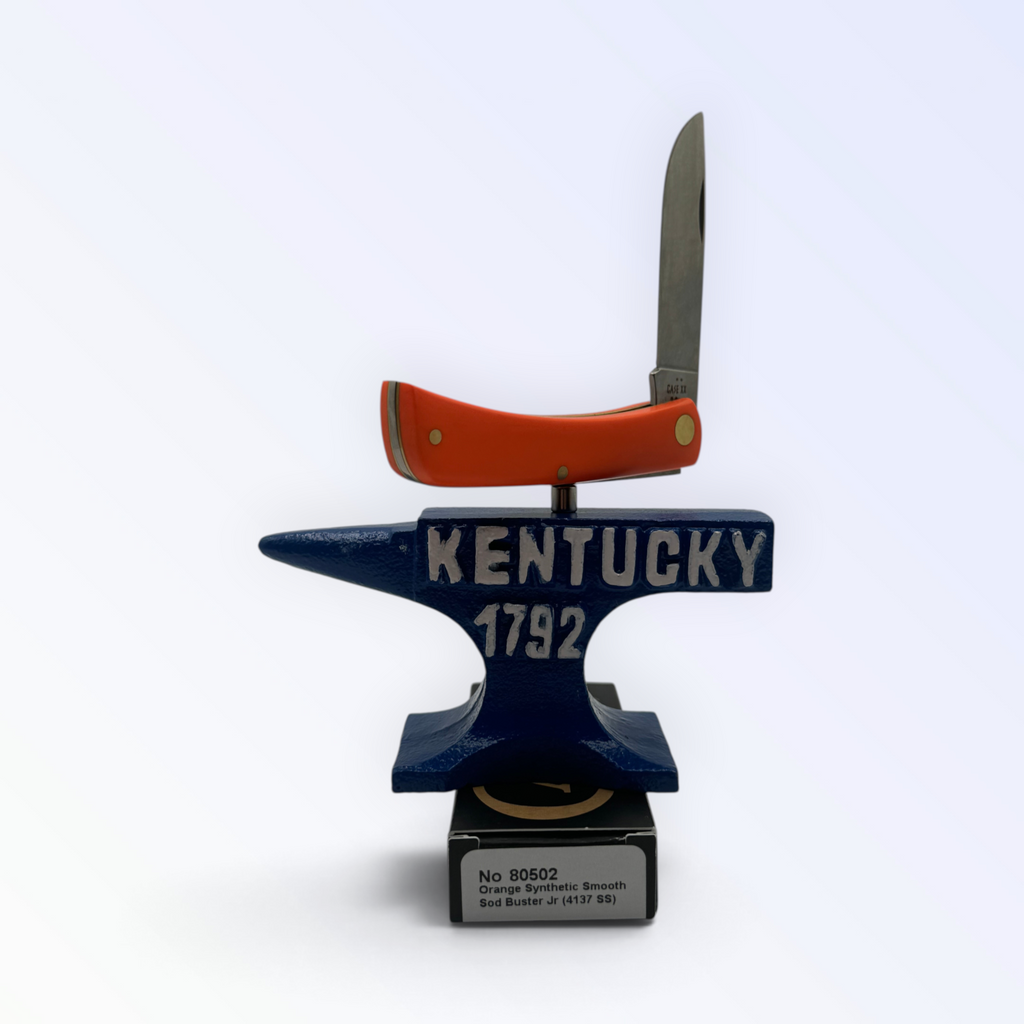 Pigeon Roost Knives Case XX Sod Buster Jr pocket knife with a smooth orange synthetic handle balanced on an anvil