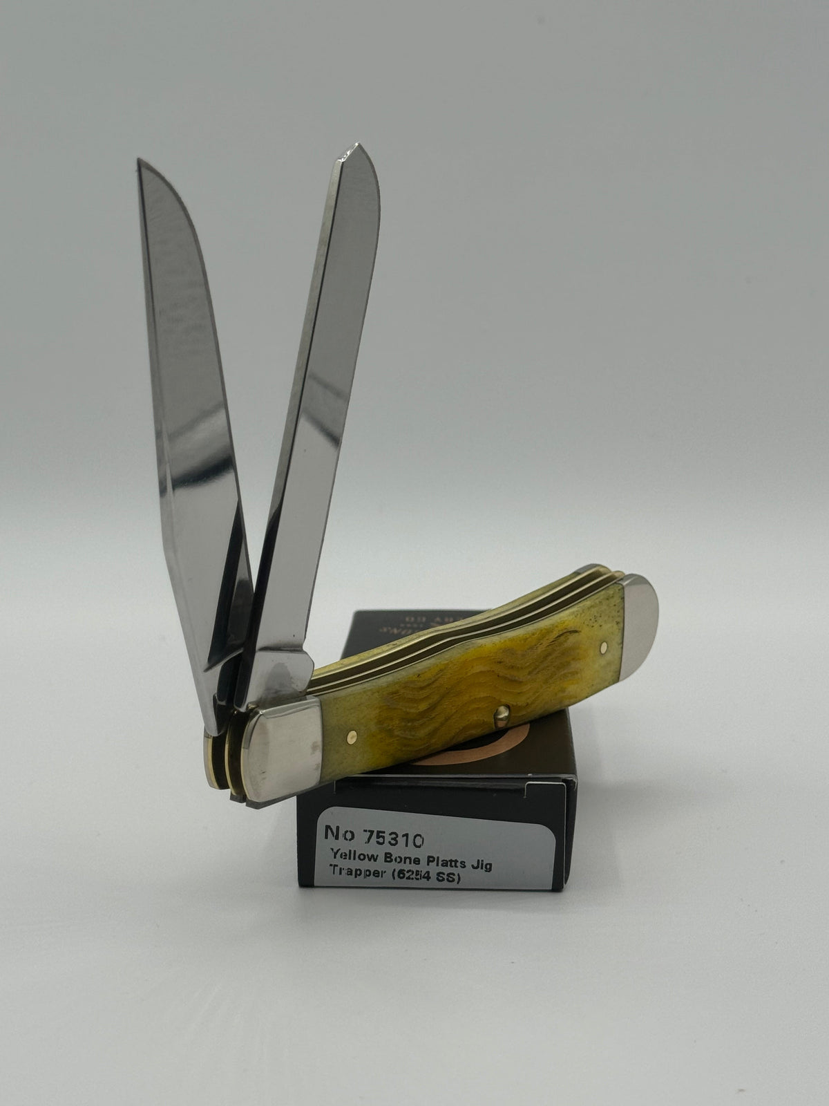 Pigeon Roost Knives Case XX Trapper pocket knife with yellow Platts jigged bone handle and two stainless steel blades.