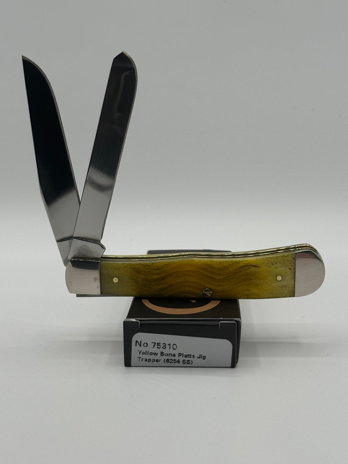 Pigeon Roost Knives Case XX Trapper pocket knife with yellow Platts jigged bone handle and two stainless steel blades.